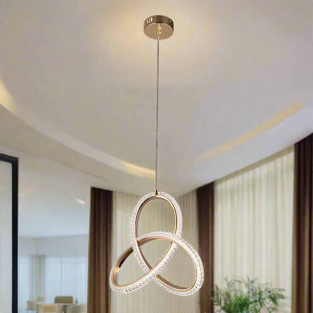 Modern pendant light with interlocking rings on a white background