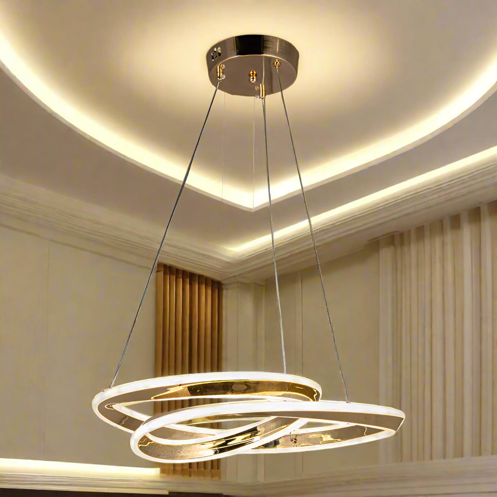 Gold pendant light with two interlocking rings on a white background