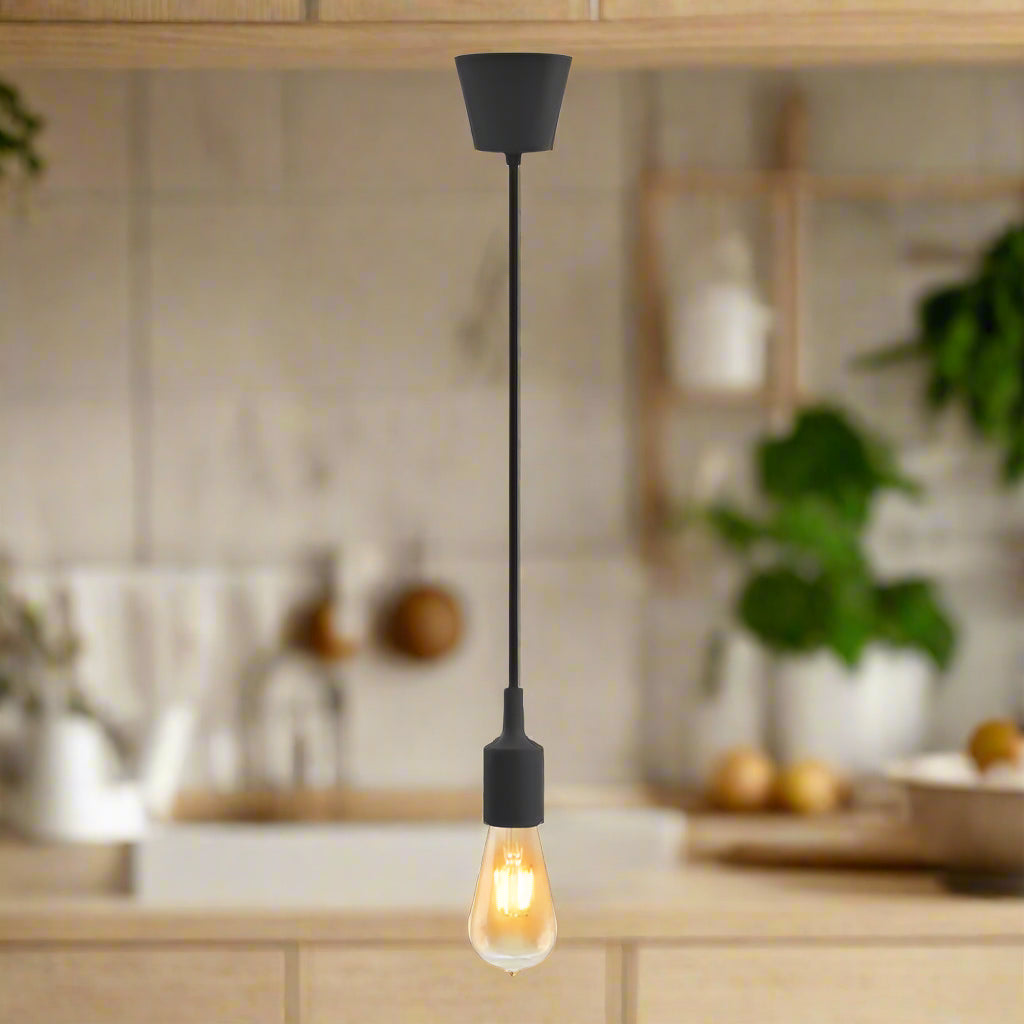 Black pendant light with a lit bulb on a white background