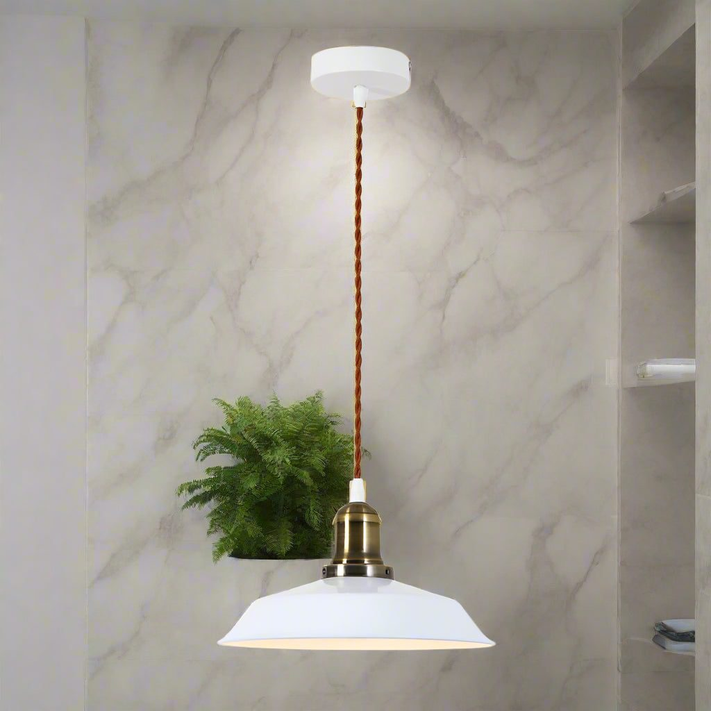 Pendant light with white shade and brass fitting on a white background