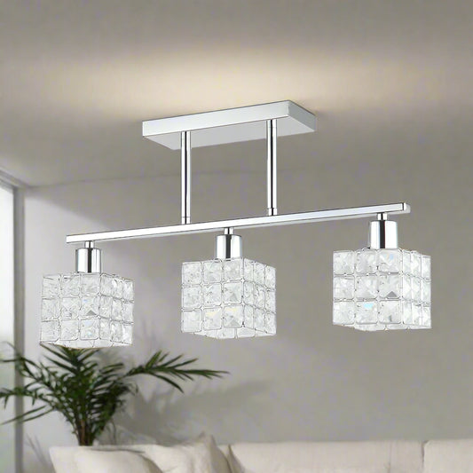 Ceiling light fixture with three crystal lampshades on a white background