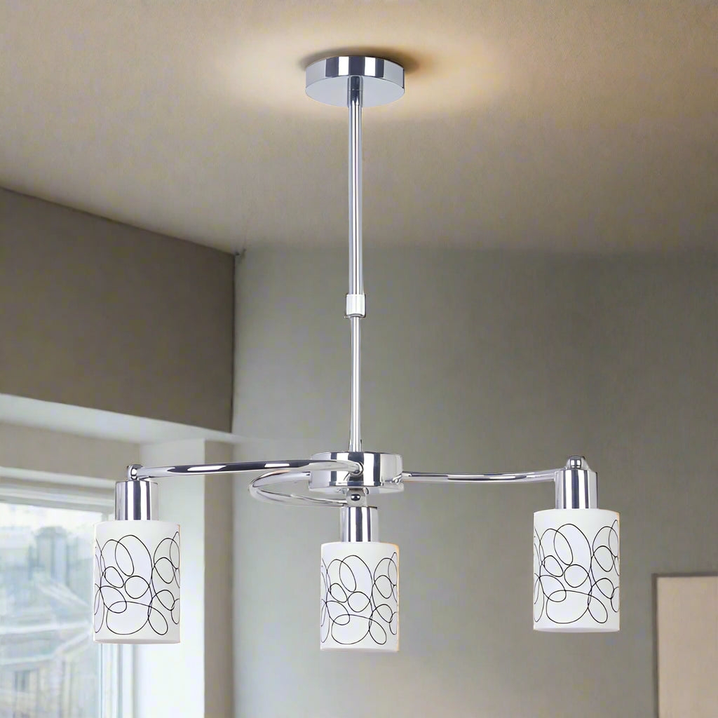 Modern chandelier with three white lampshades on a white background