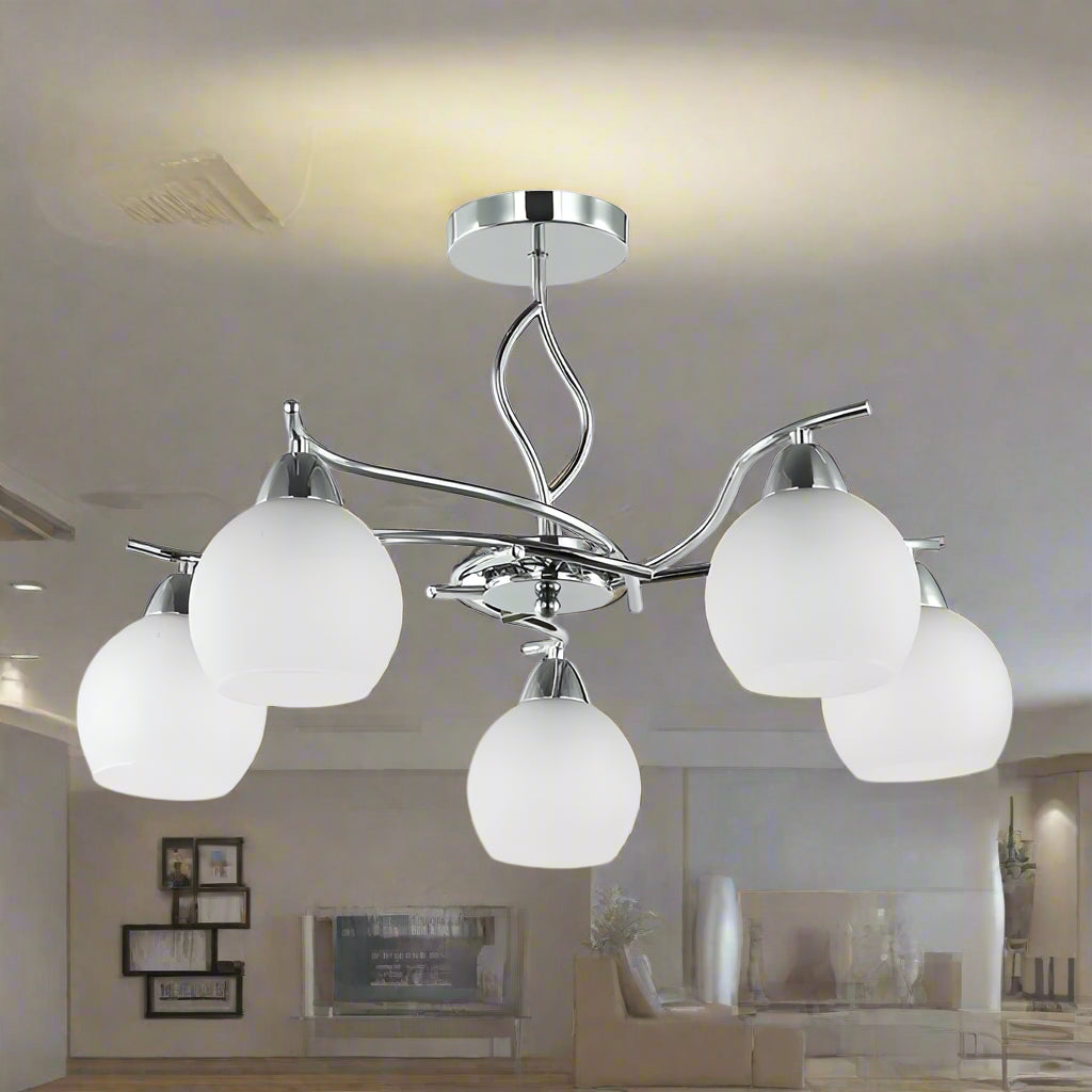 Chandelier with five white glass shades on a white background