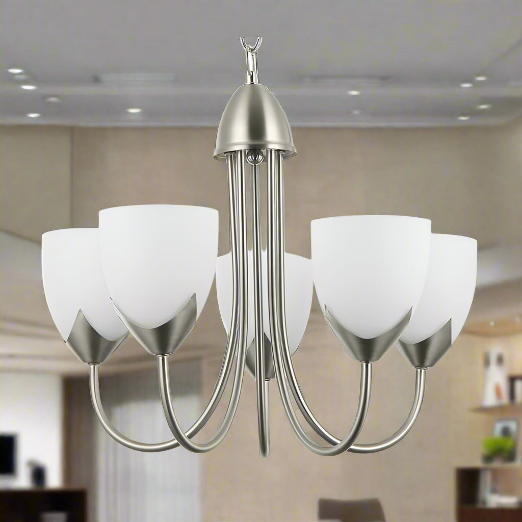 Chandelier with white glass shades and metallic finish on a white background