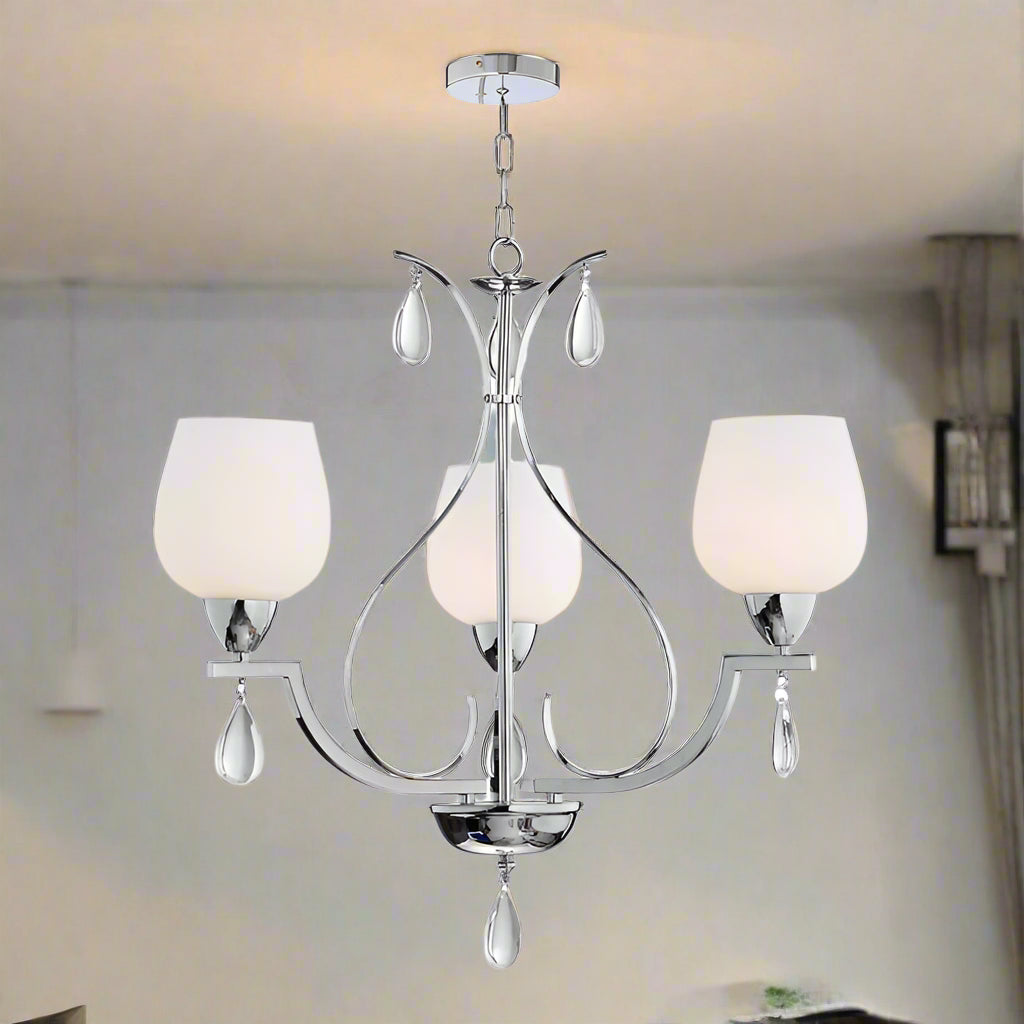 Chandelier with three white glass shades on a white background