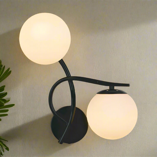 Modern wall light fixture with black frame and two round glass shades on a white background