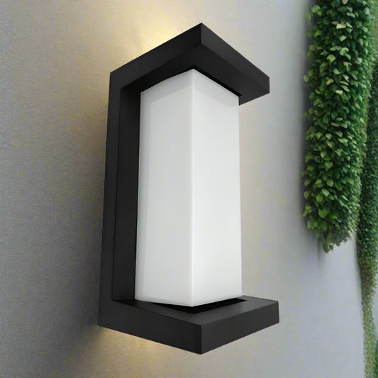 Black outdoor wall light fixture with white glass on a white background
